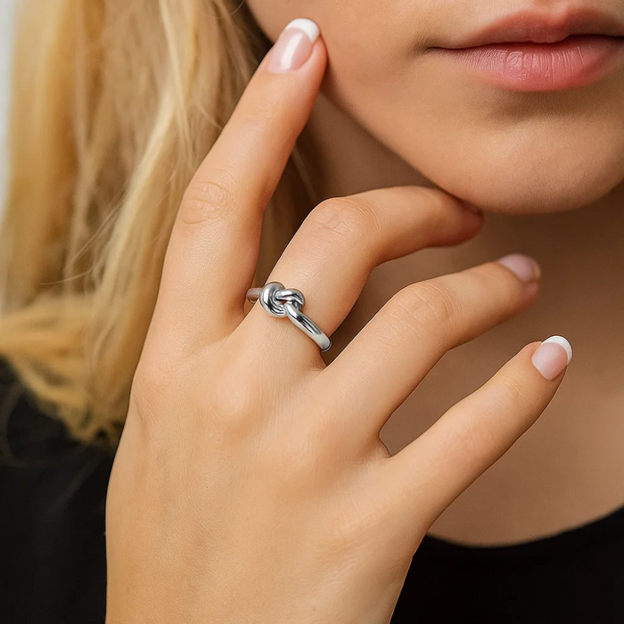 Silver love-knot ring with twisted knot detail and polished band