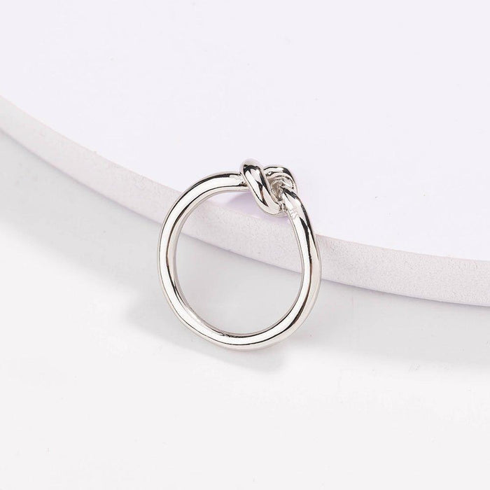 Silver love knot commitment ring with sculpted knot top, polished finish