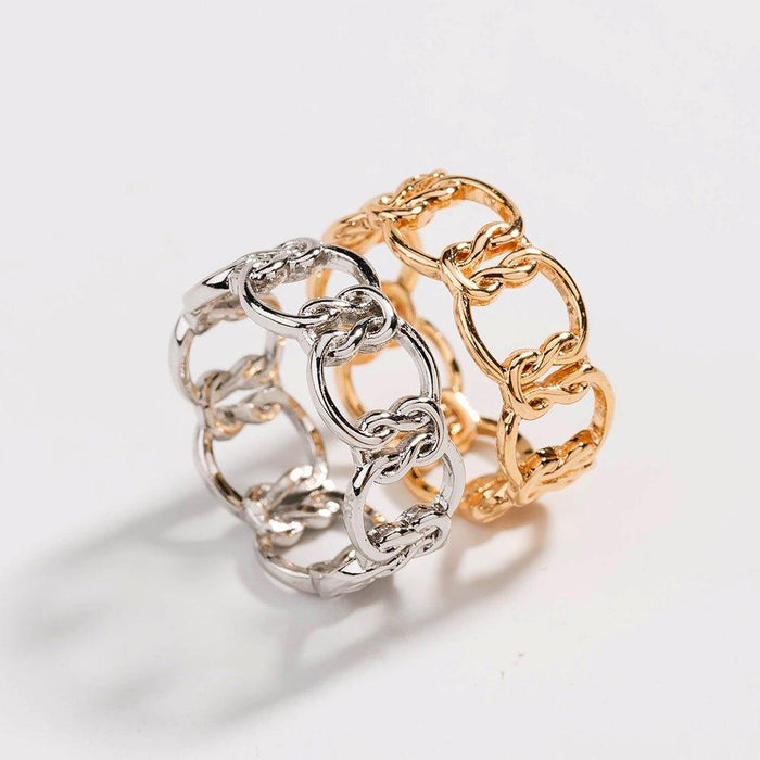 Two love-knot chain rings in gold and silver, interlocking links