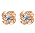 Rose gold love knot stud earrings with clear center stones and pavé accents