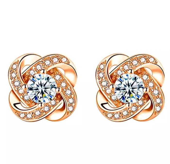 Rose gold love knot stud earrings with clear center stones and pavé accents