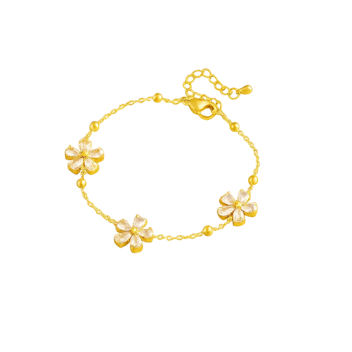 Gold-tone crystal blossom bracelet featuring three flower charms along the chain