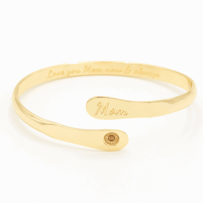 Gold-tone engraved mom cuff bracelet with script “Mom” and round emblem