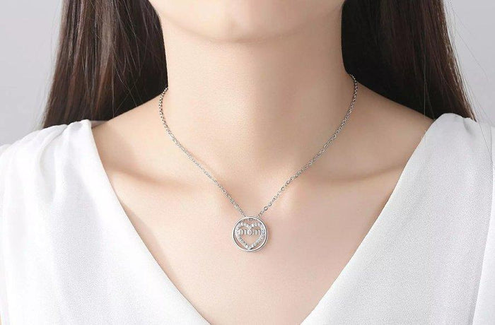 Silver round pendant necklace with glitter heart and 'Mom' text medallion