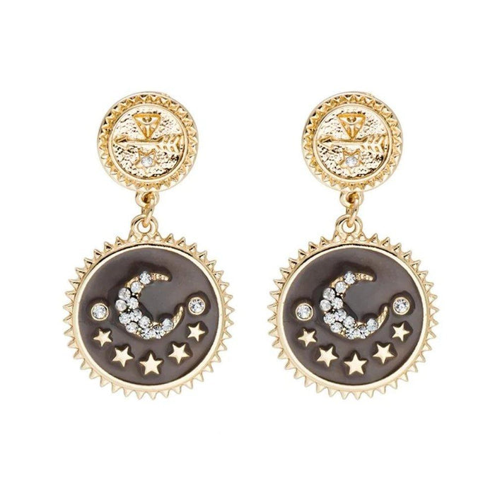 Gold-tone moon and star dangle earrings with dark round enamel and crystal accents