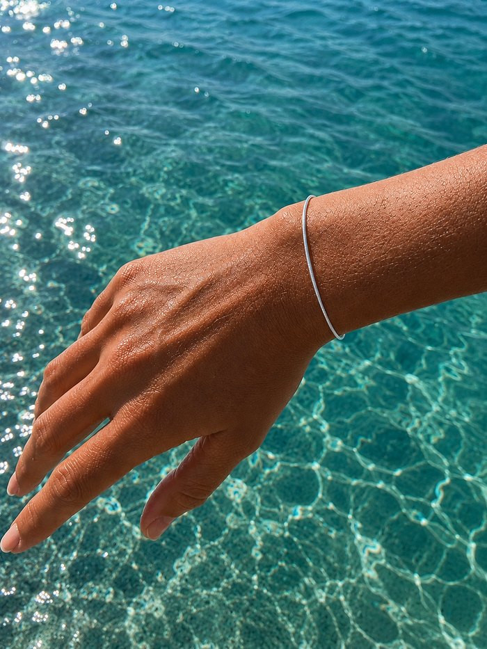 Minimalist Ocean Current Bracelet Silver crafted from 925 sterling silver with a delicate adjustable chain and polished silver finish.