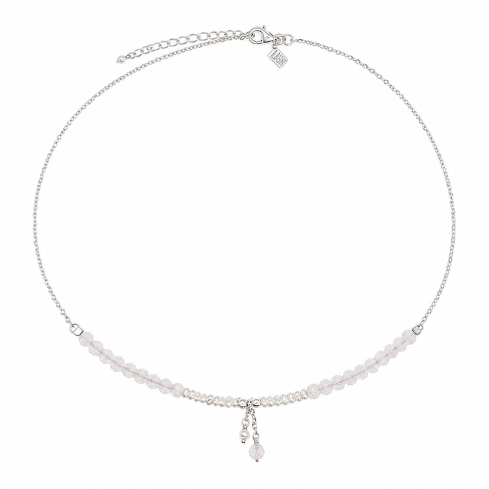A delicate silver chain necklace featuring a horizontal row of small, pale pink faceted beads and a matching dangling charm, displayed on a clean white background.