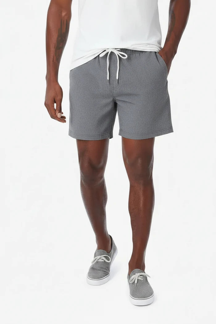 Person wearing gray shorts with a white drawstring on a white background