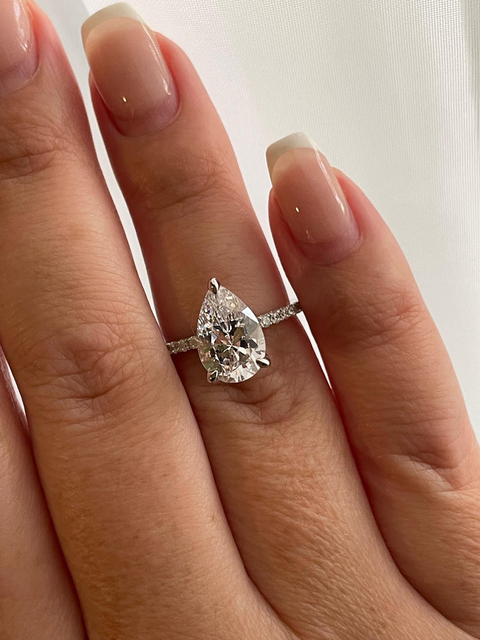 Pear cut ring with hidden halo. Sterling Silver 925 engagement ring with 3CT pear shaped simulated diamond and hidden halo.