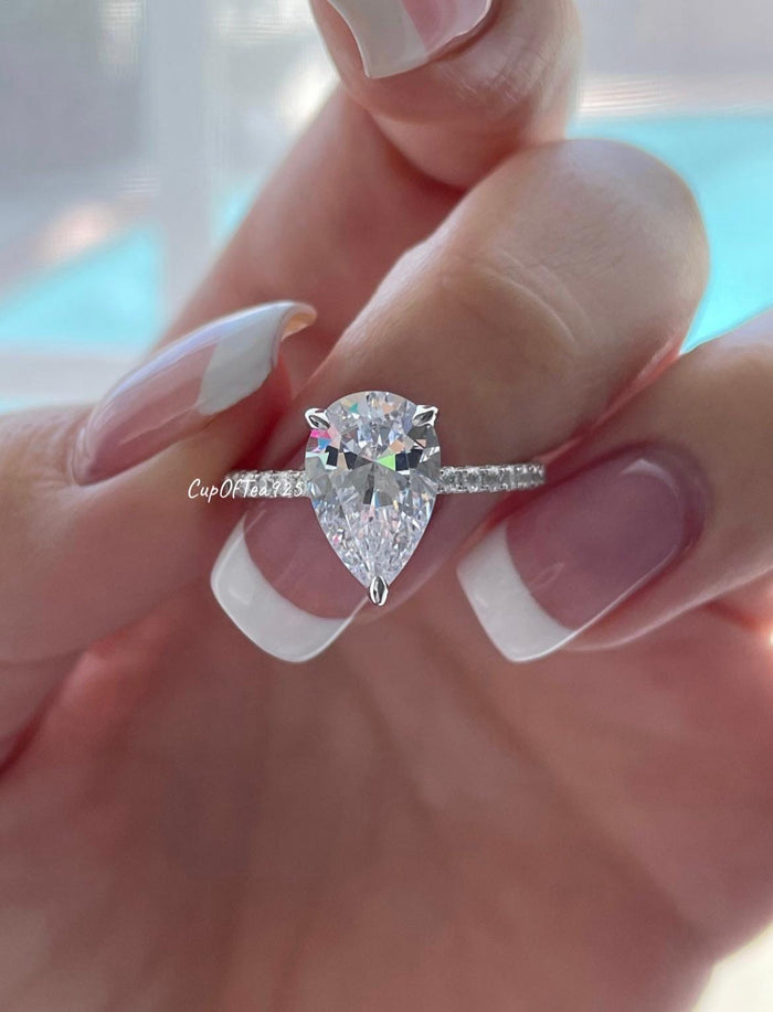 Pear cut ring with hidden halo. Sterling Silver 925 engagement ring with 3CT pear shaped simulated diamond and hidden halo.