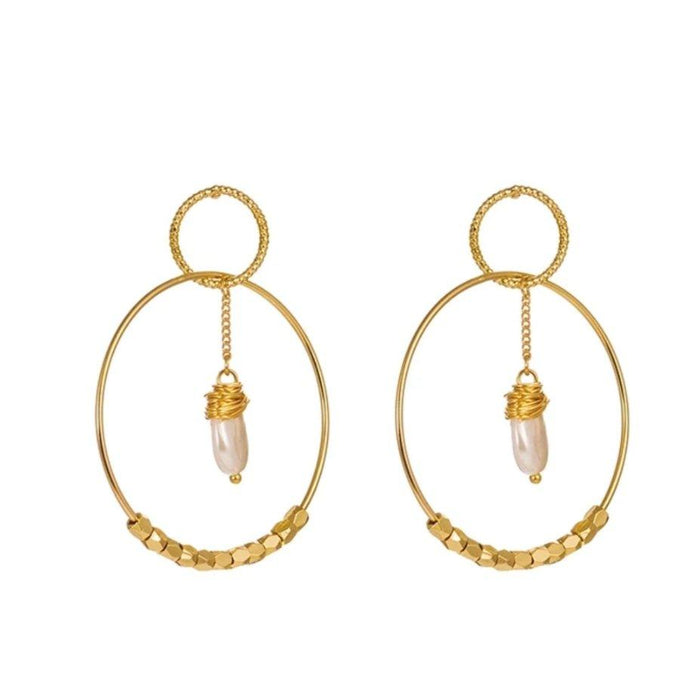 Gold double hoop earrings with small pearl drop charms and textured hoop details.
