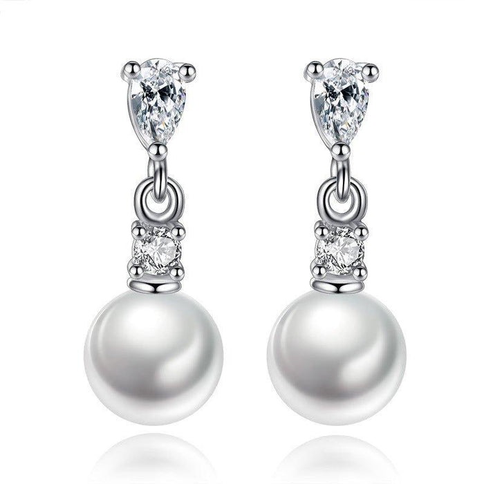 Silver-tone pearl drop earrings with cubic zirconia accents and dangling round pearl