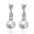 Silver-tone pearl drop earrings with cubic zirconia accents and dangling round pearl