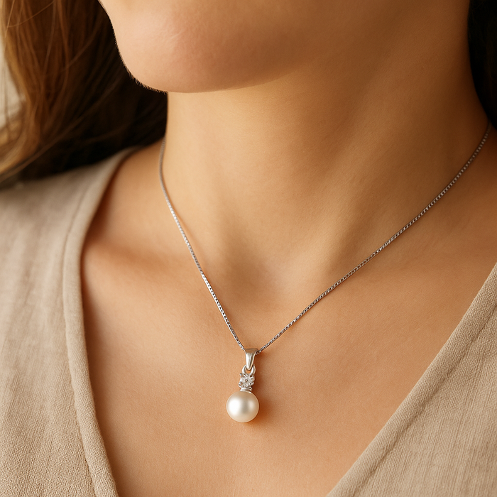 Silver pearl pendant necklace with small cubic zirconia detail on thin chain