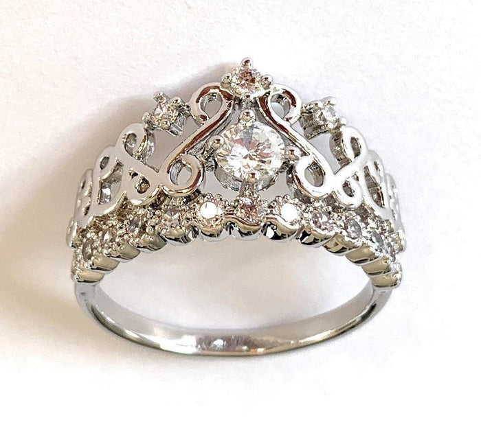 Silver crown ring with large round cubic zirconia center and small accent stones