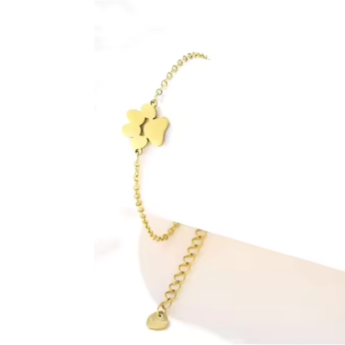Gold link chain paw cutout charm bracelet with dangling paw charm and small tag charm