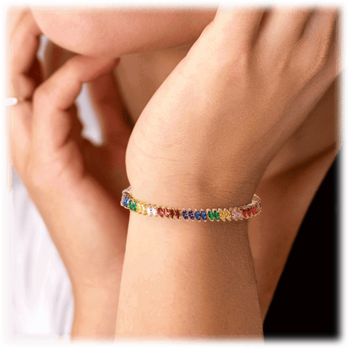 Rainbow tennis bracelet on wrist with small marquise multicolor stones