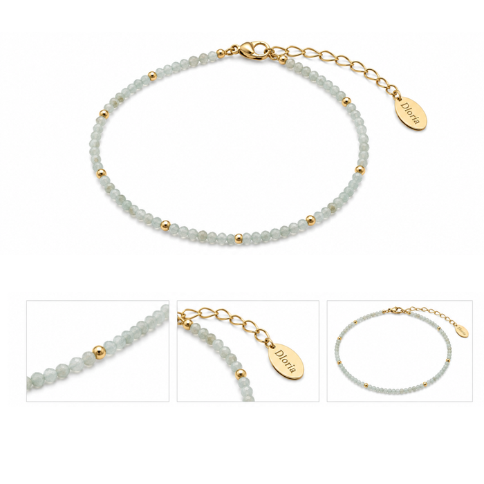 Light blue beaded bracelet with gold chain clasp and Dorie charm tag, flat lay