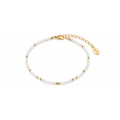 White beaded bracelet with gold chain clasp and Dorie charm tag