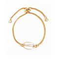 Gold seashell charm bracelet with adjustable spring clasp and small crystal beads.