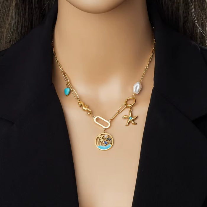 Gold-tone turquoise charm necklace with heart bead, starfish charm, round ocean pendant