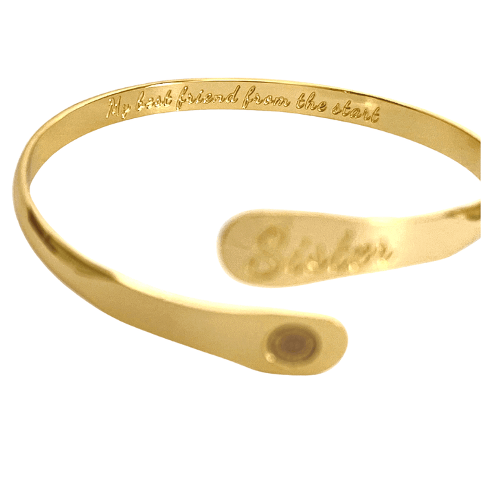 Gold cuff bracelet with engraved inside text and oval centerpiece