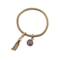 Gold-tone tassel charm bracelet with oval mauve stone pendant and chain loop clasp