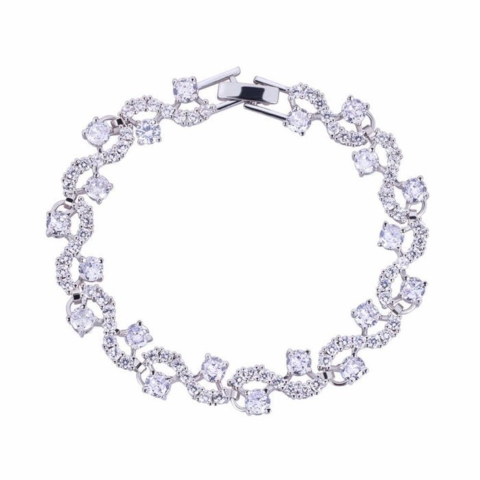 Round-cut cubic zirconia tennis bracelet in silver-tone, flexible oval link design.
