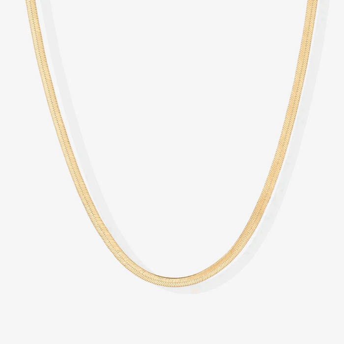 Gold snake chain necklace close-up, smooth slim links