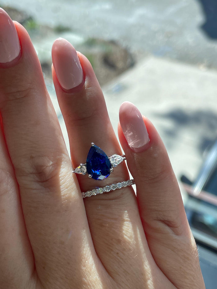 There stone engagement ring with pear cut crushed ice blue sapphire and moissanite half eternity band, September birthstone ring