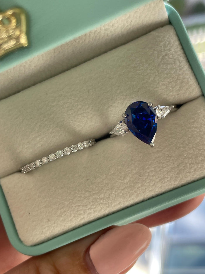 There stone engagement ring with pear cut crushed ice blue sapphire and moissanite half eternity band, September birthstone ring