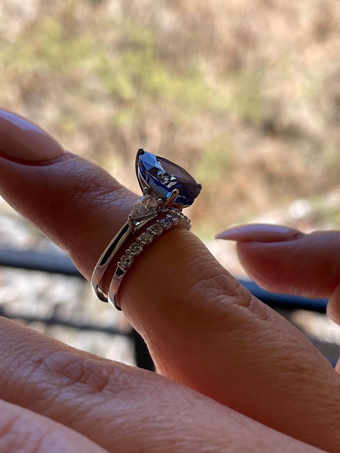 There stone engagement ring with pear cut crushed ice blue sapphire and moissanite half eternity band, September birthstone ring