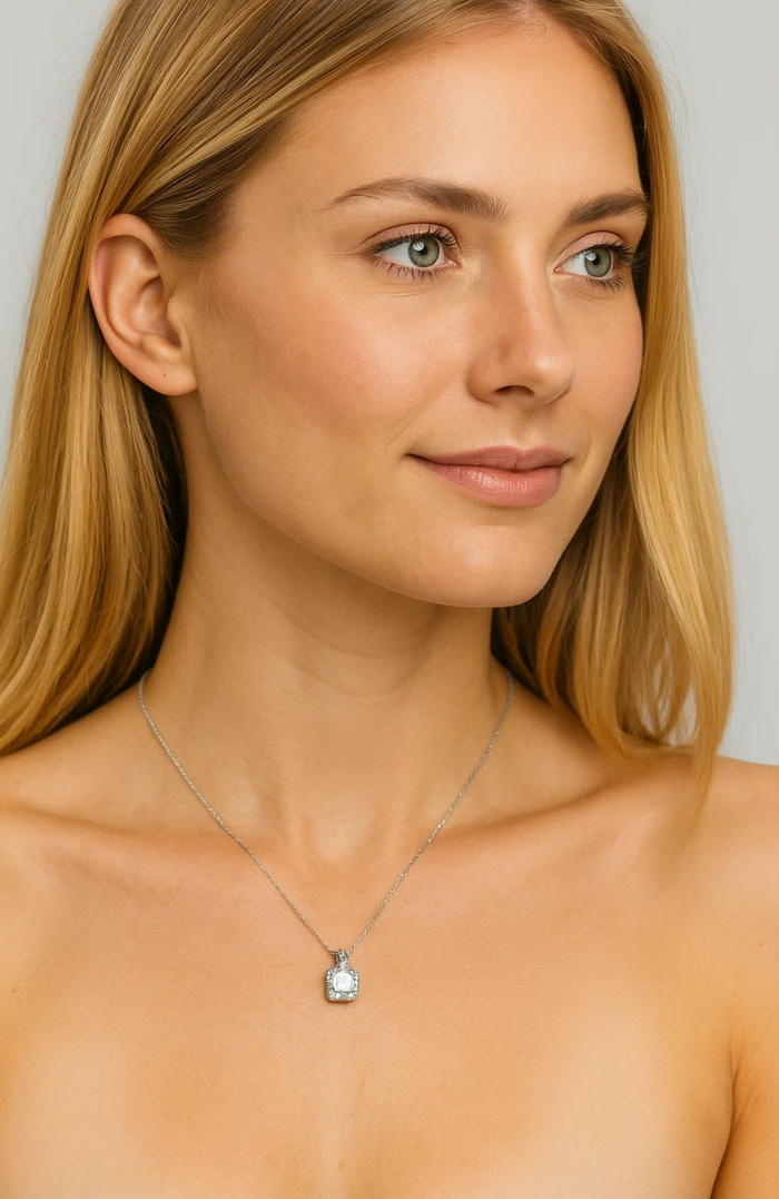 Silver-tone cubic zirconia halo pendant necklace with cushion center stone on fine chain.