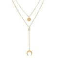 Two-layer gold necklace with moon charms, coin medallion, and pearl drop