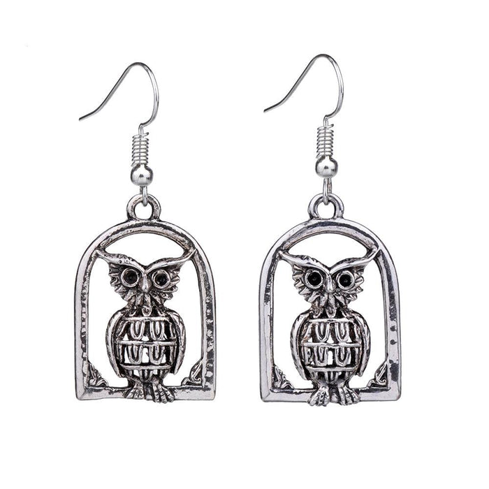 Silver-tone owl drop dangle earrings with arched frame and detailed owl face.