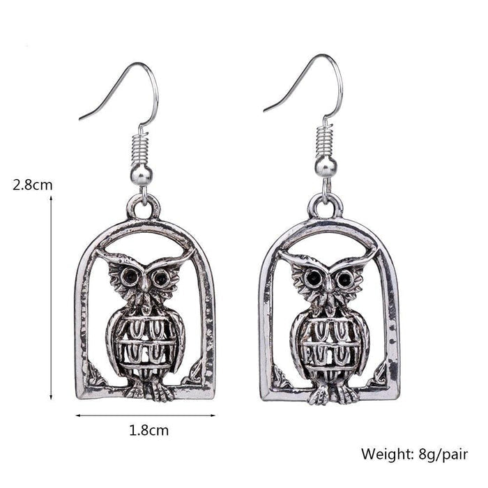 Silver-tone owl drop dangle earrings with arched frame; 2.8 cm long, 1.8 cm wide.