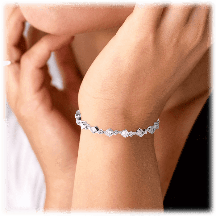 Silver-tone tennis bracelet with rectangular clear CZ stones on wrist