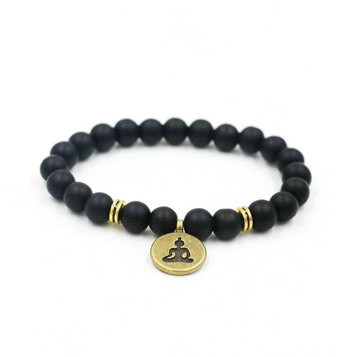 Black bead yoga bracelet with gold Buddha charm and two gold accent rings