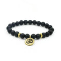 Black beaded yoga bracelet with round gold-tone om charm and spacer accents